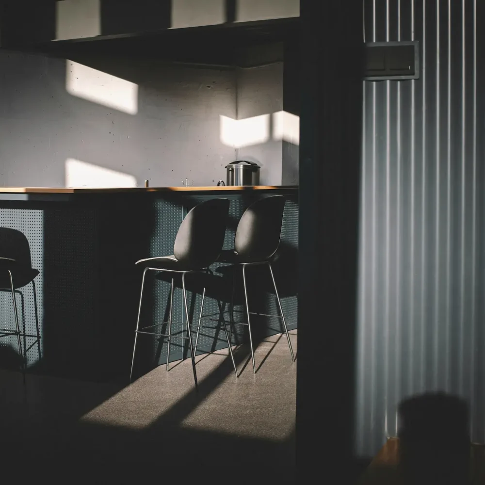 A stylish room scene with a wooden counter and several stools